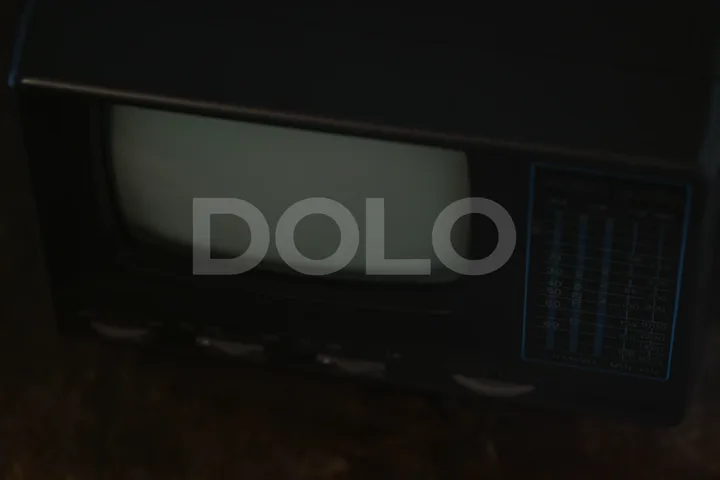 Low-Angle View of a Vintage Television Being Tuned